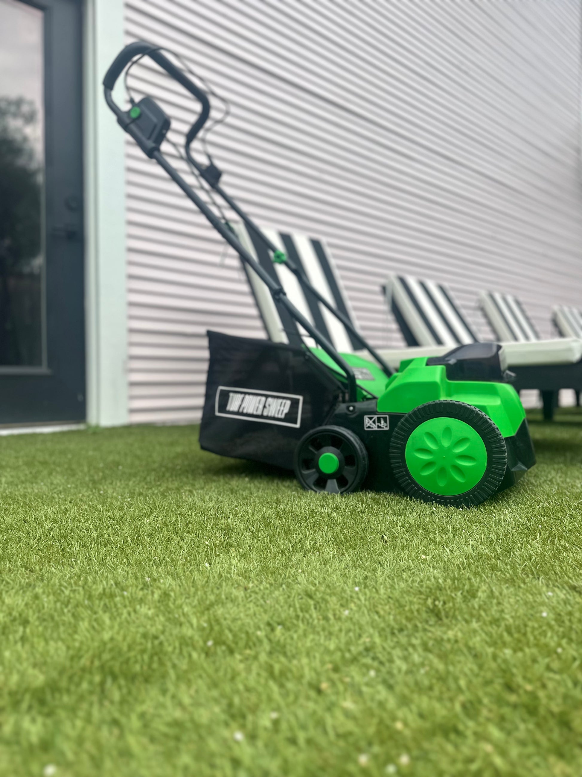Green and Black Turf Power Sweep On Artificial Grass That Has Been Cleaned