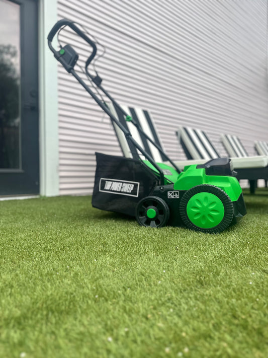 Green and Black Turf Power Sweep On Artificial Grass That Has Been Cleaned